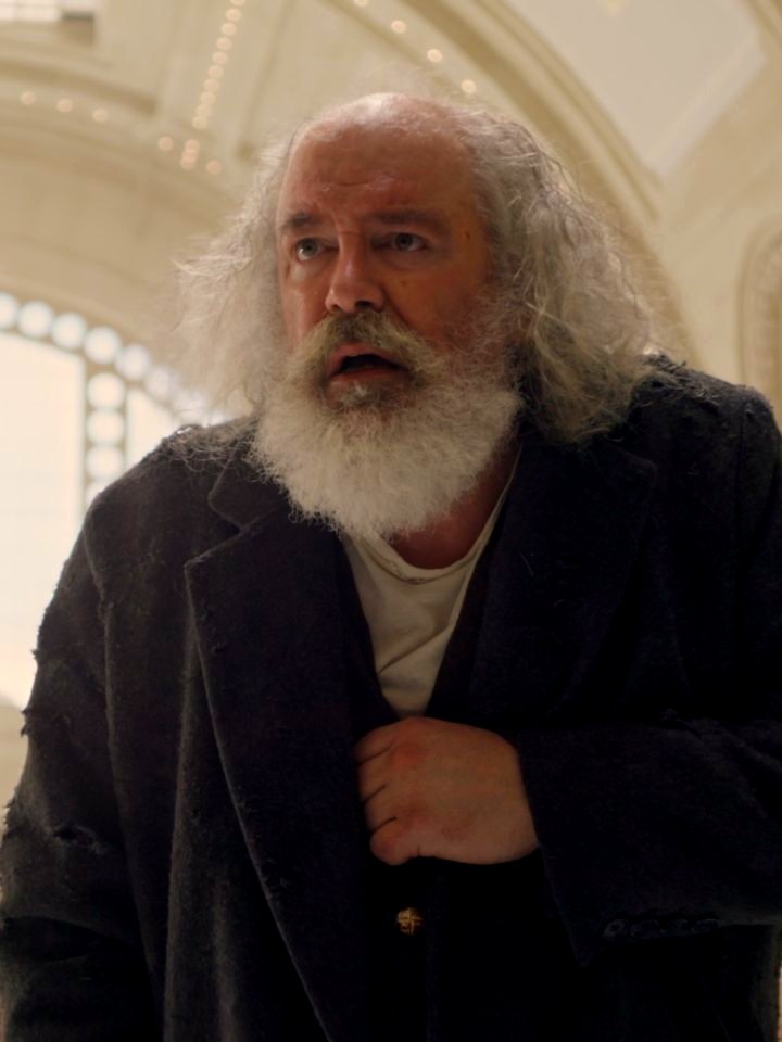 Charles Leggett as Arthur in the hall of Union Station, clutching his coat